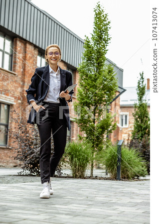 Young business woman in black looking contented 107413074