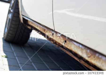 Rotten sills of an old gray car Rotten sills of an old gray car 107413349