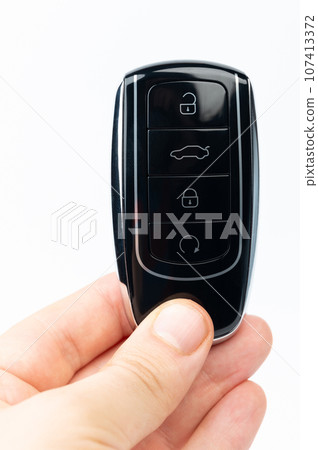 Hand hold black car key 107413372