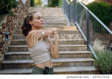 Beautiful diabetic woman preparing for outdoor run in the city. 107413559