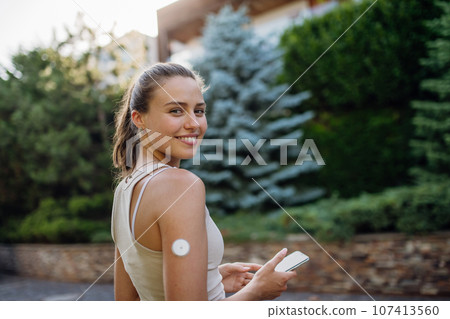 Beautiful diabetic woman preparing for outdoor workout in the city. 107413560