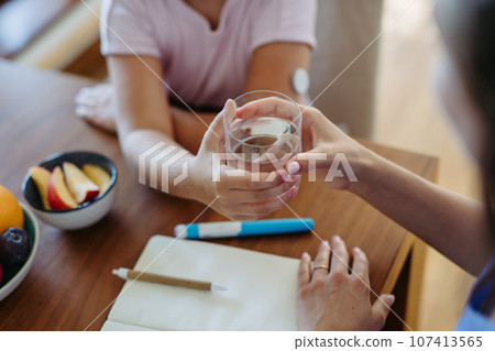 Girl drinking water to better manage her diabetes. Girl drinking water to better manage her diabetes. 107413565