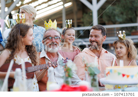 Family having birthday garden party. Family having birthday garden party. 107413701