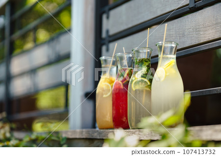 Colorful fresh lemonades in glass bottles. 107413732