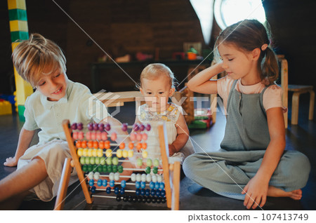 Children are playing together in indoor play area at a restaurant. 107413749