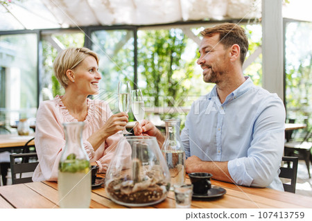 Portrait of beautiful couple in a restaurant, on a romantic date. 107413759