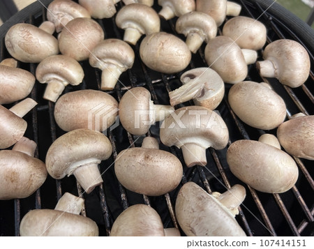Raw champignon mushroom in bbq grill homemade juicy 107414151