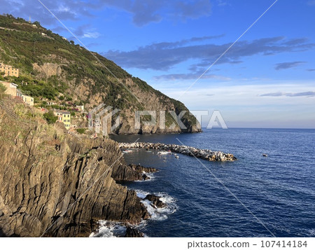 Evening Riomaggiore shore stones and mountains view cinque terre cliffs 107414184