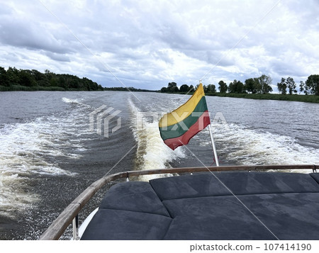 Flag of Lithuania on background of sea and shore. Flag of Lithuania on background of sea and shore. 107414190