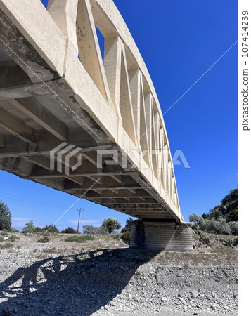 A road arched bridge over a dried river on the island of Rhodes A road arched bridge over a dried river on the island of Rhodes 107414239