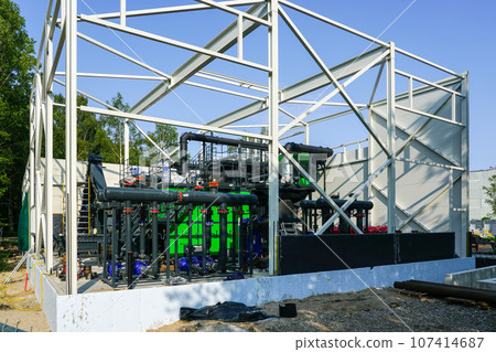 Steel framework of new wood chip biofuel heat power station before installing wall sandwich panels Steel framework of new wood chip biofuel heat power station before installing wall sandwich panels 107414687