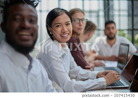 Multiethnic business people working together in the office Multiethnic business people working together in the office 107415430