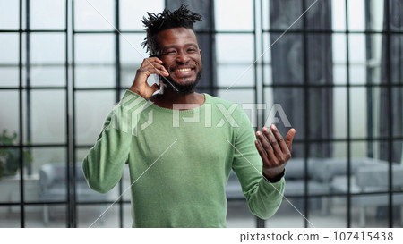 Modern young man with mobile phone in the office. 107415438