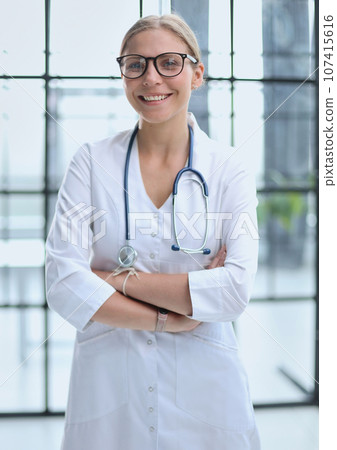 Portrait of a young doctor with glasses in a hospital 107415616