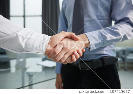 Close-up image of businesspeople shaking hand during the the meeting. 107415637