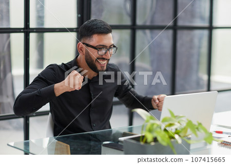 Business man sitting at his desk in the office 107415665
