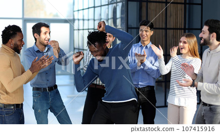 happy excited millennial employees shouting for joy, raising hands for emotional high fives. 107415916