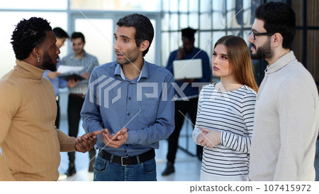 Group of smiling young business people discussing new ideas 107415972