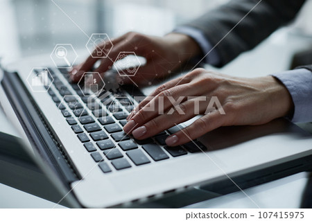 Close-up of male hands using laptop at office Close-up of male hands using laptop at office 107415975