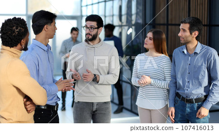 Business people discussing over new business project in office. 107416013