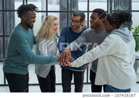 Closeup. joyful business team with folded hands together 107416167