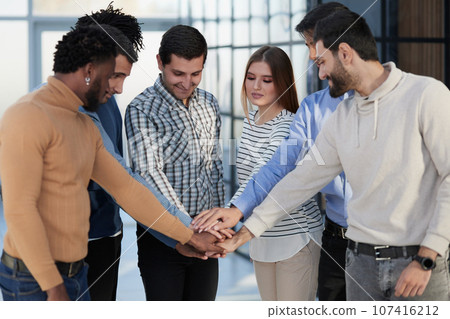 Happy colleagues welcome businessman to their successful team Happy colleagues welcome businessman to their successful team 107416212