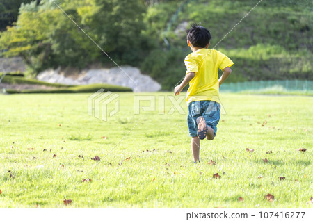 Back view of a running boy 107416277