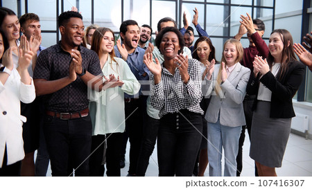 Business people clapping their hands after a seminar 107416307