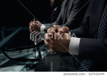 Close up of male hands holding a pair of glasses 107416344