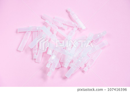 Medical eye drops in plastic pipettes. Plastic vials of saline solution 107416396