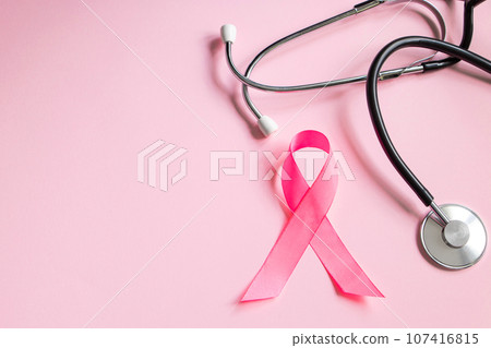 Breast Cancer Awareness Month. Pink ribbon and stethoscope on colored background. Women's health care concept. Symbol of fight against oncology. Breast Cancer Awareness Month. Pink ribbon and stethoscope on colored background. Women's health care concept. Symbol of fight against oncology. 107416815