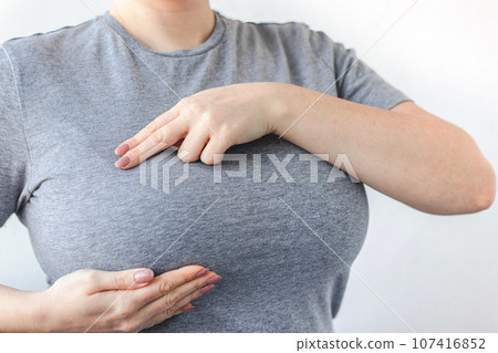 Young woman doing breast self-diagnosis. Breast Cancer Awareness Month. Women's health care 107416852