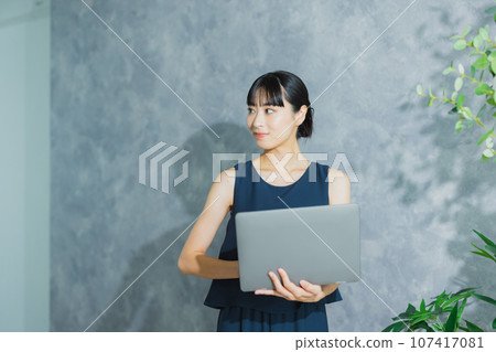 A woman using a computer A woman using a computer 107417081