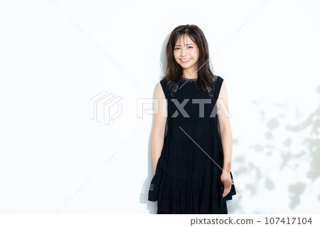 A woman in a black dress 107417104