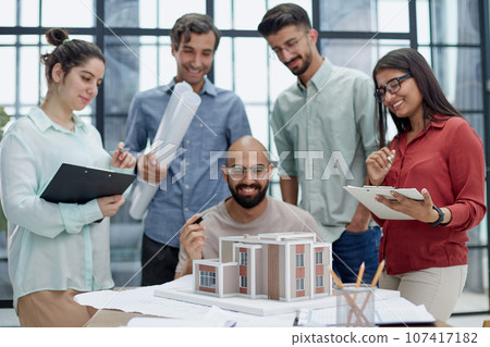 Architects and designers working on house layout in office studio. 107417182