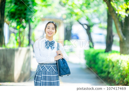 High school girl walks outside in uniform High school girl walks outside in uniform 107417469