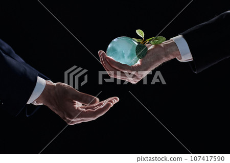 Plabt Growing inside a Sphere - Hand Holding - Eco Concept 107417590