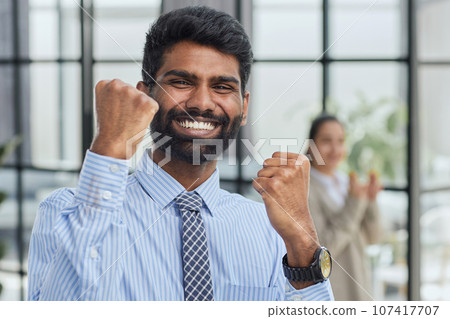 a man holding his hand up a gesture of triumph and victory. 107417707