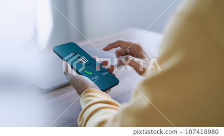 Man answering the incoming call. The phone call was from an unknown number. Call center gang or stranger. Hoax person with a fake identity. Concept of scam, fraud with a smartphone from the criminal. 107418980