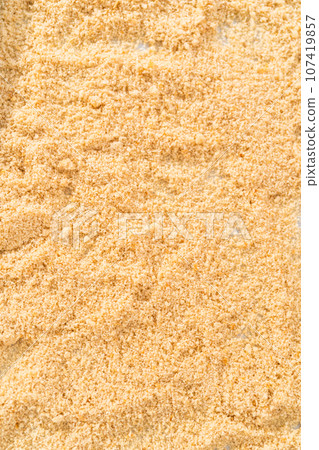 Spreading bread crumbs on a baking sheet lined with parchment paper to prepare dried bread crumbs. Spreading bread crumbs on a baking sheet lined with parchment paper to prepare dried bread crumbs. 107419857
