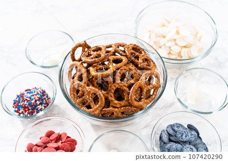 Measured ingredients in glass mixing bowls to prepare red, white, and blue chocolate-covered pretzel twists. Measured ingredients in glass mixing bowls to prepare red, white, and blue chocolate-covered pretzel twists. 107420290