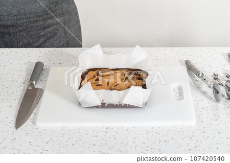 Scoring chocolate fudge with peanut butter swirl for cutting into small pieces. Scoring chocolate fudge with peanut butter swirl for cutting into small pieces. 107420540