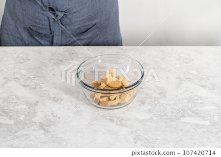 Soaking stale bread in milk to make meatloaf. 107420714
