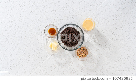 Flat lay. Measured ingredients in glass mixing bowls to make chocolate fudge with peanut butter swirl. Flat lay. Measured ingredients in glass mixing bowls to make chocolate fudge with peanut butter swirl. 107420955