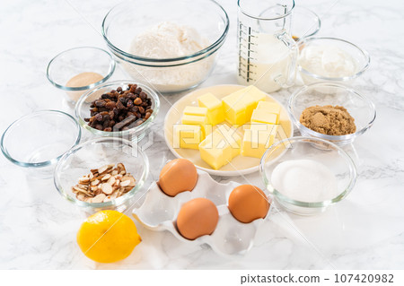 Measured ingredients in glass mixing bowls to bake mini Easter bread kulich. Measured ingredients in glass mixing bowls to bake mini Easter bread kulich. 107420982