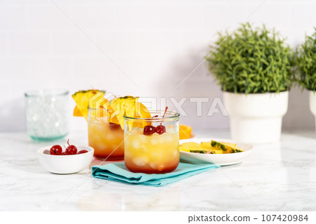 Step by step. Garnishing unset cocktail garnished with a slice of fresh orange and pineapple. Step by step. Garnishing unset cocktail garnished with a slice of fresh orange and pineapple. 107420984