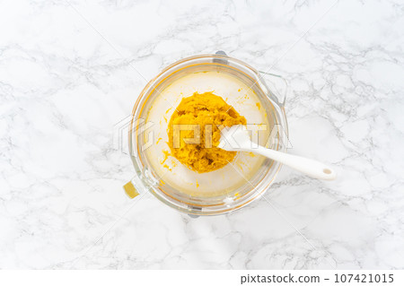 Flat lay. Lemon wedge cookies with lemon glaze. Mixing ingredients in kitchen mixer to bake lemon wedge cookies with lemon glaze. 107421015