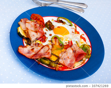 scrambled eggs with bacon for english traditional breakfast 107421269