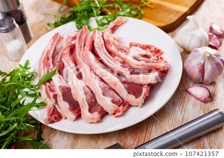 Fresh uncooked lamb chops on plate 107421357