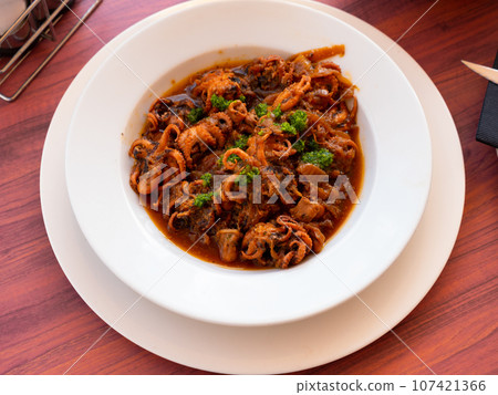 Miini octopuses with tomato sauce and onions Miini octopuses with tomato sauce and onions 107421366